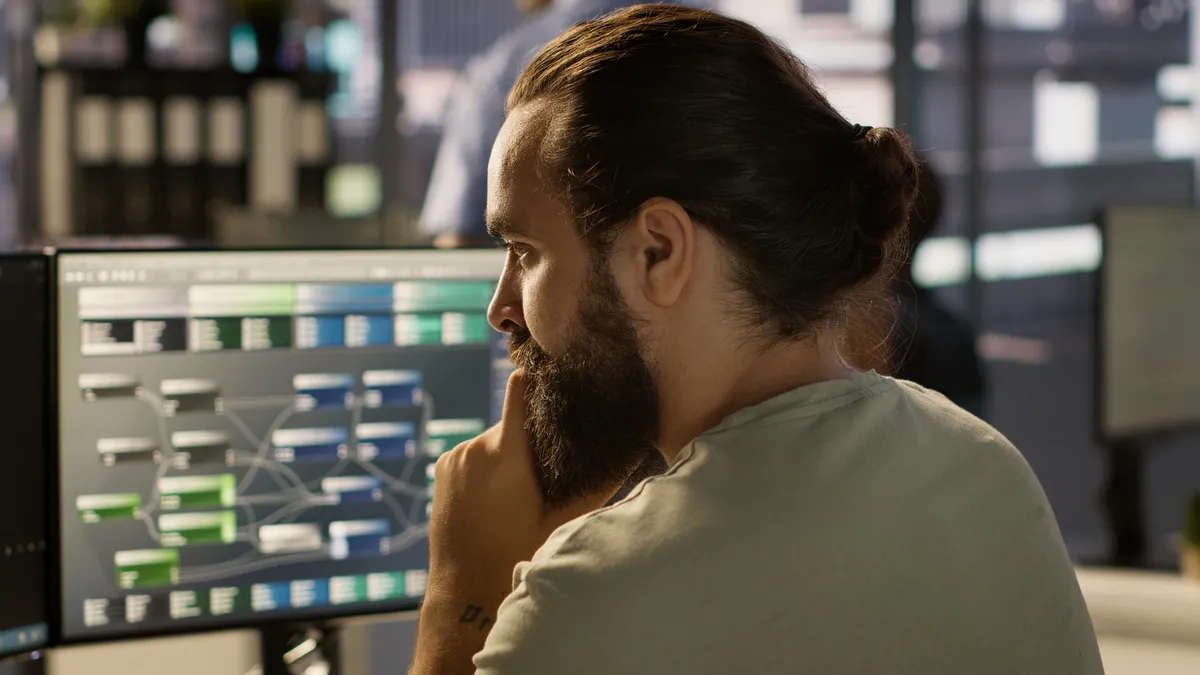 A professional analysing technical information on screens.
